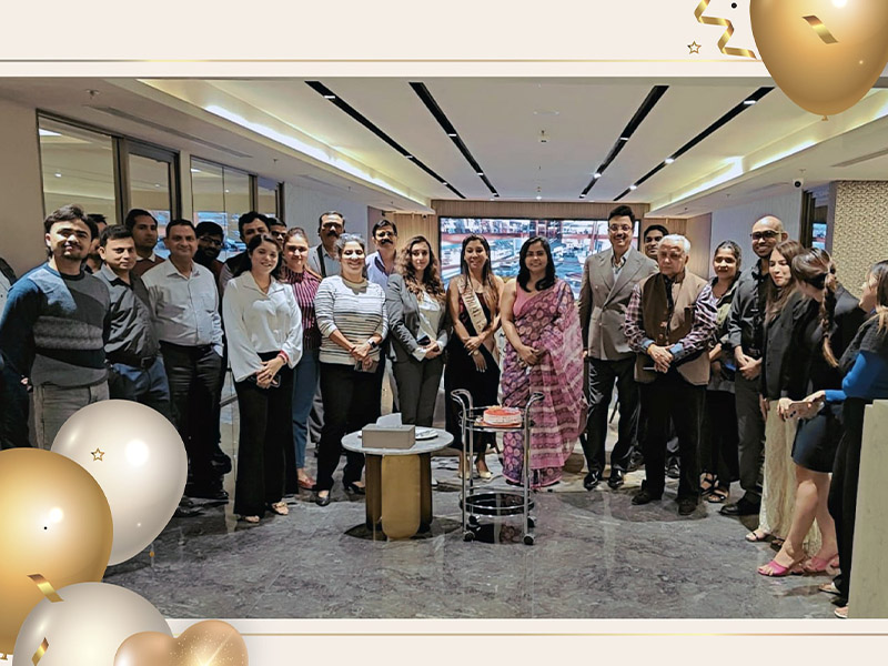 Aarize employees celebrating a birthday with cake and cheerful mood in office.